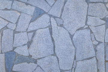 a fragment of the wall of tiles of different shapes, shot on a cloudy autumn day