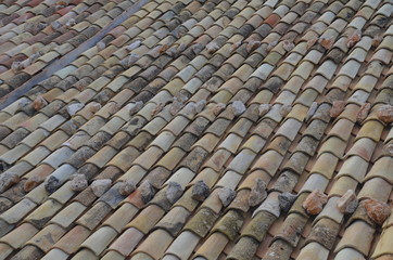 Background of old roof tiles with stones on the roof of an old house.Sicily