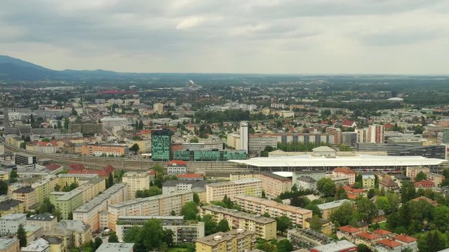 flight over salzburg city train station traffic district day time aerial panorama 4k austria