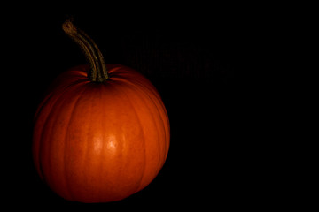 Pumpkin in darkness. Halloween mood. Copy space.