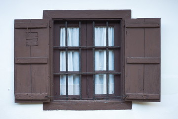 An open traditional window on a white facade