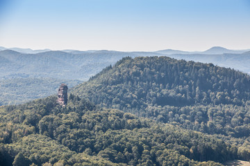 Big hill with a big rock and the green forest