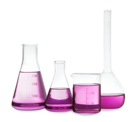 Laboratory glassware with purple liquid on white background