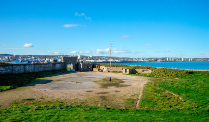 Scottish flag in the center of historical Torry battery ruins and Aberdeen cityscape, Scotland