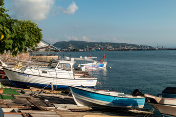 Fototapeta na wymiar Zonguldak eregli district, fishing boats and erdemir iron and steel factory behind