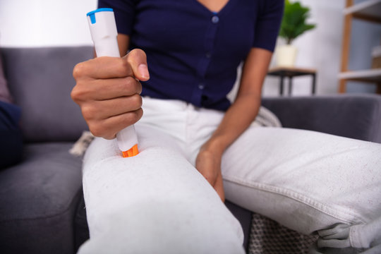 Woman Injecting Epinephrine Using Auto-injector Syringe