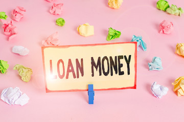 Conceptual hand writing showing Loan Money. Concept meaning Something lent or furnished on condition being returned Colored crumpled papers empty reminder pink floor clothespin