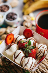 turkish loam. turkish bite dessert with chocolate and white chocolate sauce. strawberry and banana new generation bite