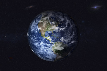 Planet Earth with night city lights in the space with far galaxy on the background. North and south...
