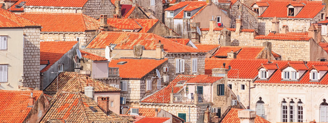Fototapeta na wymiar Summer mediterranean cityscape, banner - view of the roofs of the Old Town of Dubrovnik, on the Adriatic coast of Croatia