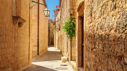 Mediterranean summer cityscape - view of a medieval street in the Old Town of Hvar, on the island of Hvar, the Adriatic coast of Croatia
