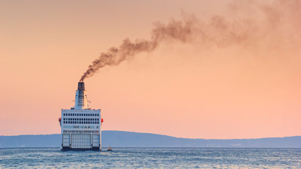 Summer seascape with sunset view - the ship leaves port for the open sea, port of Split on the Adriatic coast of Croatia