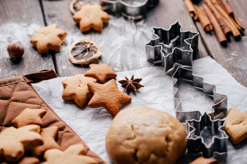 Christmas and New Year celebration traditions. Traditional festive food, family culinary. Freshly baked ready to decorating gingerbread cookies with cutters and baking utensils on the table
