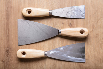 Variety Of Trowels Arranged Over Wooden Desk