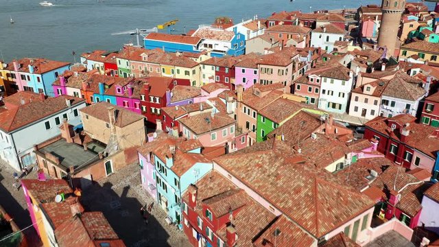 Dolly shot on the colorful typical houses and the sea of Burano (Venice, Italy). Drone footage.