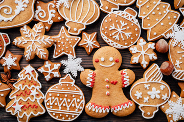Festive food, kitchen background, texture with homemade gingerbread cookies on wooden table. Christmas and New Year celebration traditions