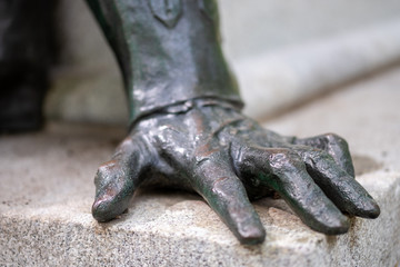 Detail of a monument showing the hand of a character