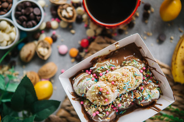 turkish lokma turkish bite dessert with chocolate and white chocolate sauce. strawberry and banana new generation bite