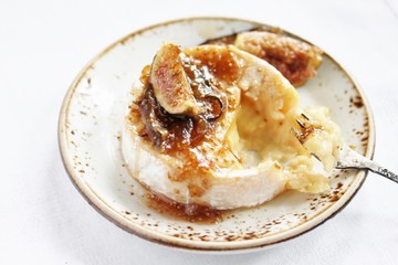 Baked Camembert cheese with fig jam and fresh figs, copy space