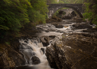 Long exposure landscape. River Moriston Falls, Invermoriston, with old stone bridges in background,...