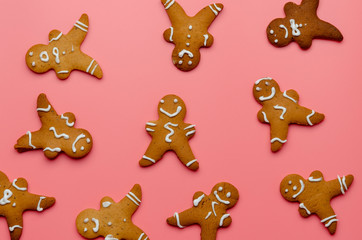 Christmas gingerbread man cookies on pink background.