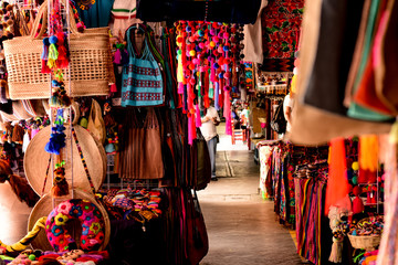 traditional Mexican street market with colorful clothes and crafts - obrazy, fototapety, plakaty