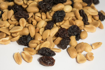  peanuts and raisins on white surface