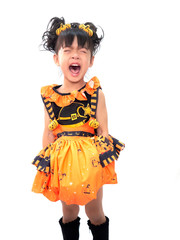 Asian children girl in pumpkin dress costume for Halloween decoration crying in white background