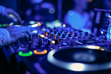 Obraz na płótnie Canvas DJs hand on mixer