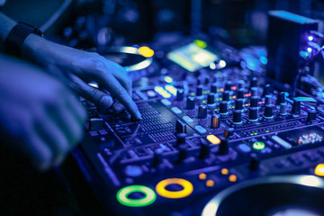 DJs hands on mixer