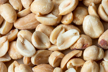 Extreme close up of hole and half roasted peanuts filling the frrame.