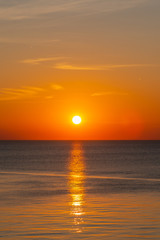 Orange sunset over calm water