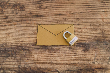 user privacy concept, email envelope miniature on desk with lock labelled security on it