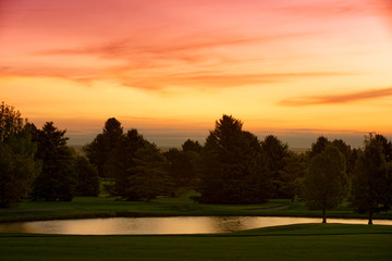 Beautiful Sunrise Clouds over trees and golf course