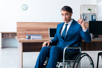 Young male employee in wheel-chair