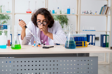 Funny male chemist working in the lab