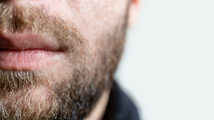 chin of a young guy with a beard, copy space