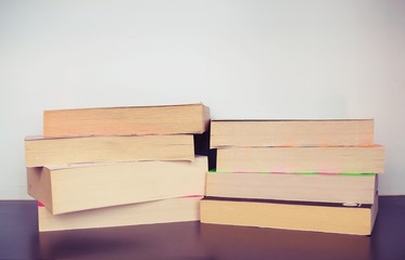 stack of old books on shelf in library.