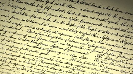 Declaration of independence of USA. Handwritten text by Thomas Jefferson and adopted by 2nd Continental Congress in Philadelphia on July 4th, 1776. Cinematic close-up panorama from up to down..