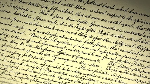 Declaration of independence of USA. Handwritten text by Thomas Jefferson and adopted by 2nd Continental Congress in Philadelphia on July 4th, 1776. Cinematic close-up panorama from up to down..