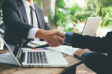 Business man shaking hand after signing contract with cooperator, Team work concept, Dealing complete