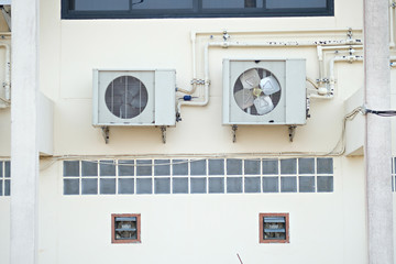 New Air conditioner compressor installed outside the house on Awning balcony with outdoor circuit breaker.