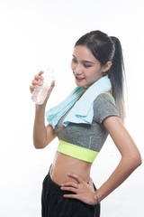 charming young girl in sports is smiling and hanging a towel and showing bottle of water, Healthy concept, Studio light portrait.