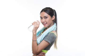 charming young girl in sports is smiling and hanging a towel and showing bottle of water, Healthy concept, Studio light portrait.