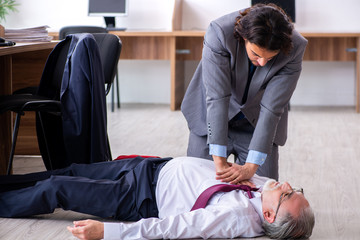 Male employee suffering from heart attack in the office