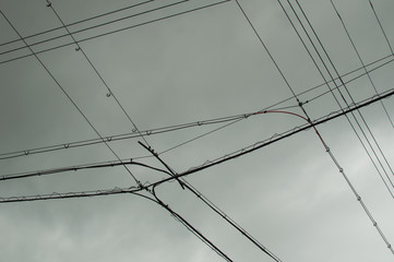 Looking up electric wires on a gloomy day