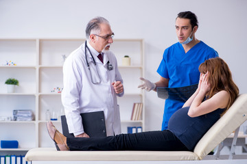 Fototapeta premium Two doctors examining young woman