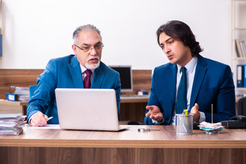 Young and old employees working together in the office