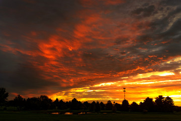 Fantastic sunrise clouds over forest