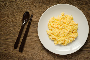 Scramble on a white plate with spoon and chopsticks